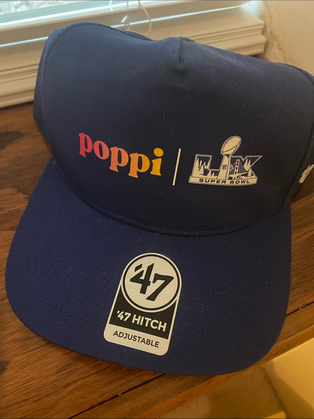 poppi navy baseball cap with multicolor poppi logo; t-shirt; hoodie, clear purse